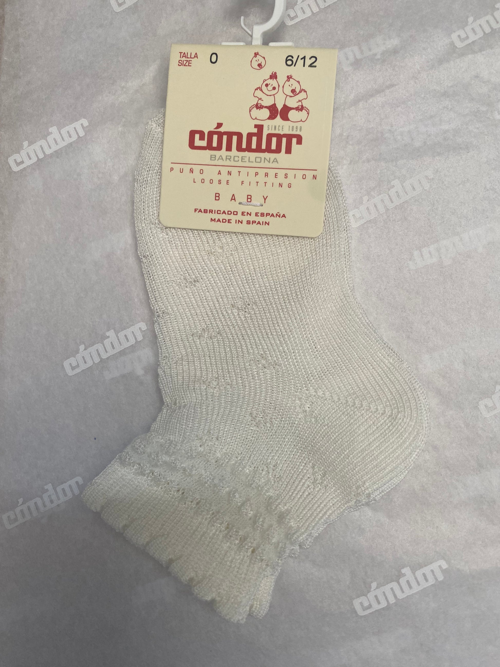 A pair of white ankle socks with a floral border pattern
